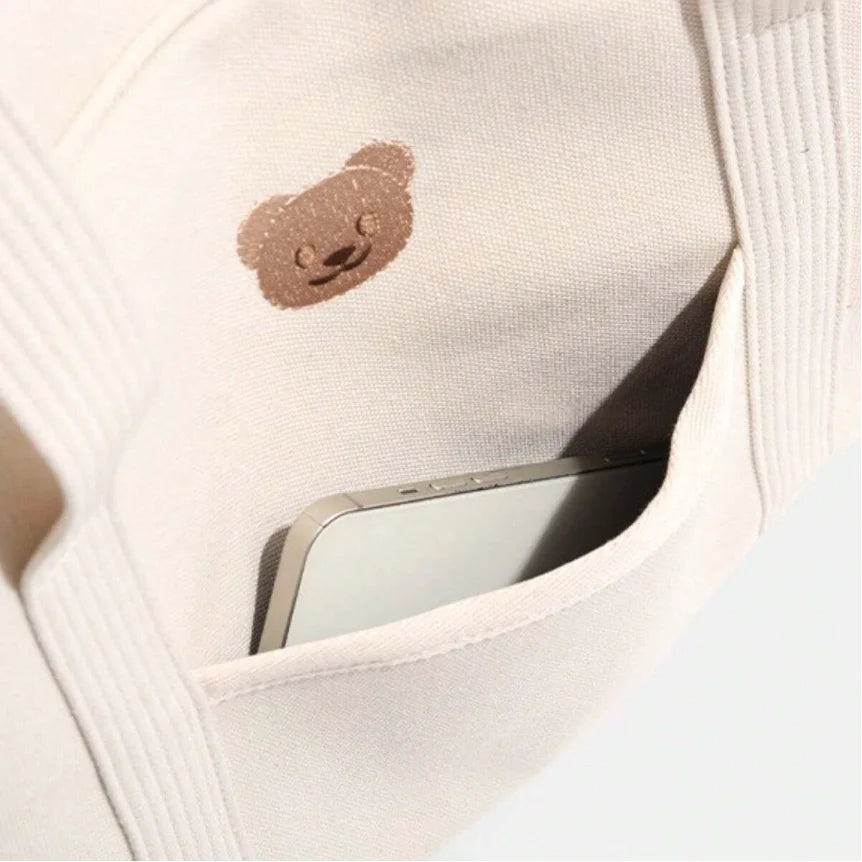 Poche extérieure avec motif ourson du sac à langer écru