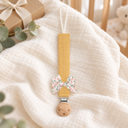 Attache-tétine en tissu jaune miel avec nœud fleuri et pince en bois