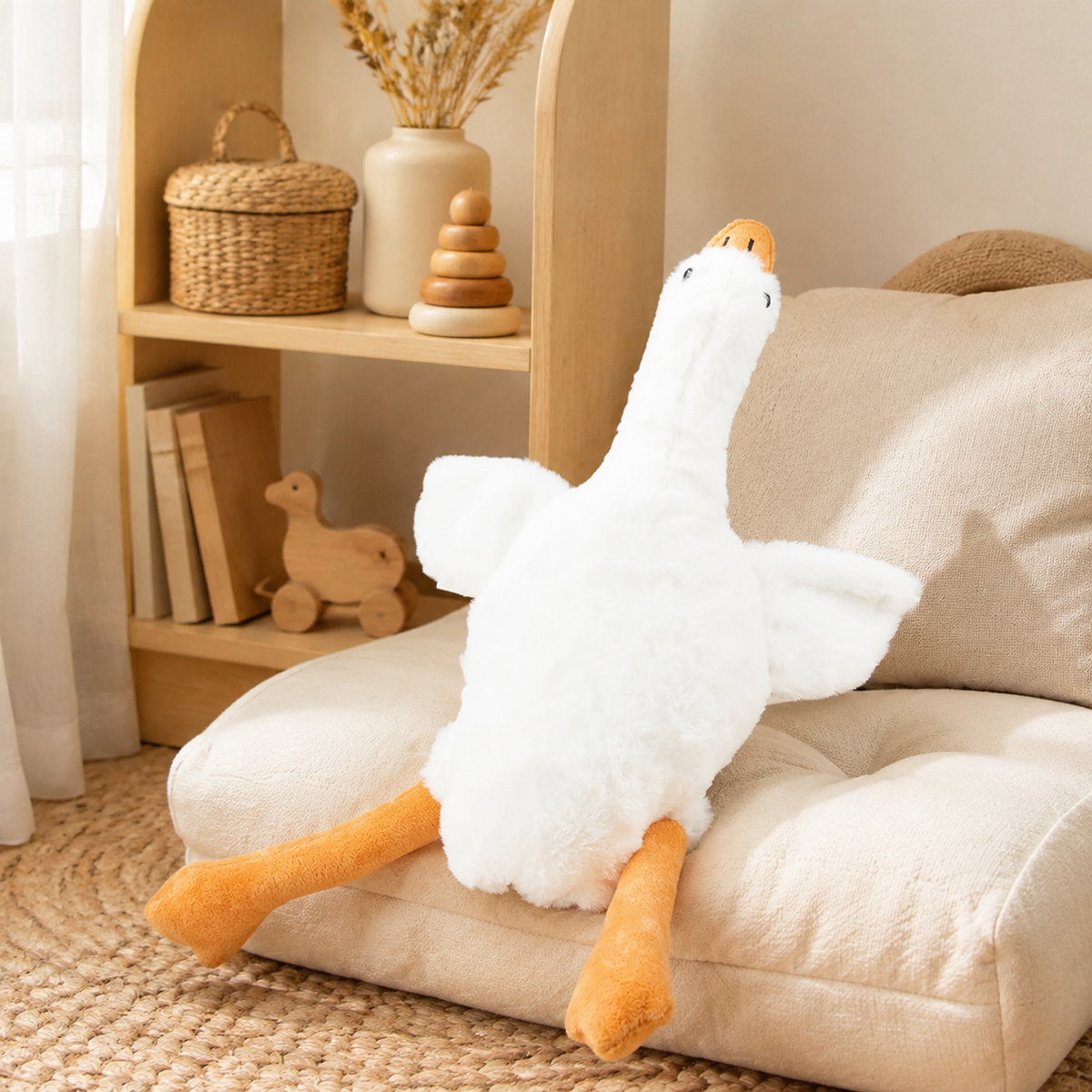 Peluche oie blanche de 50 cm dans un coin lecture de chambre enfant